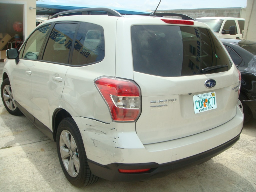 Photographs of a damaged white Subaru that was repaired by Elite Paint & Body Shop in West Palm Beach Florida
